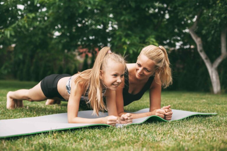 Mother's Day fitness motivation, woman and child working out outdoors.