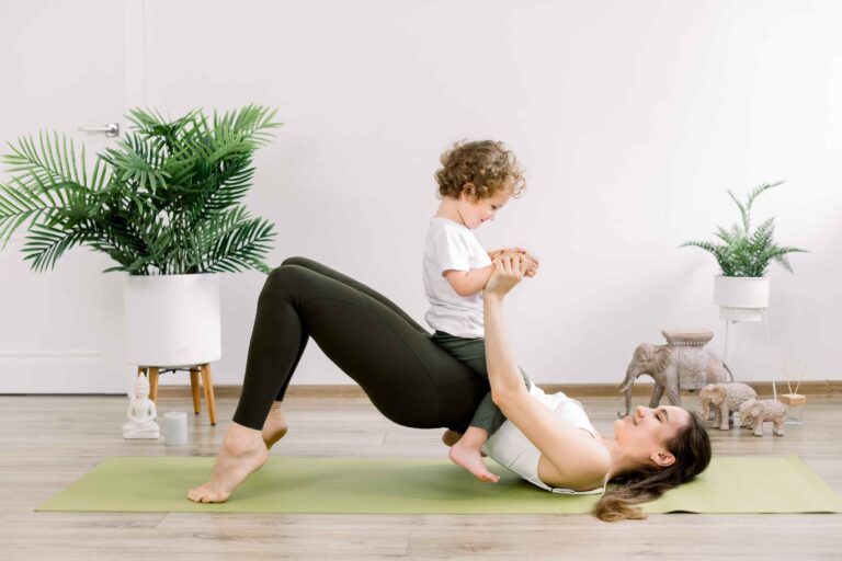 Postnatal fitness, a woman working out with her child.