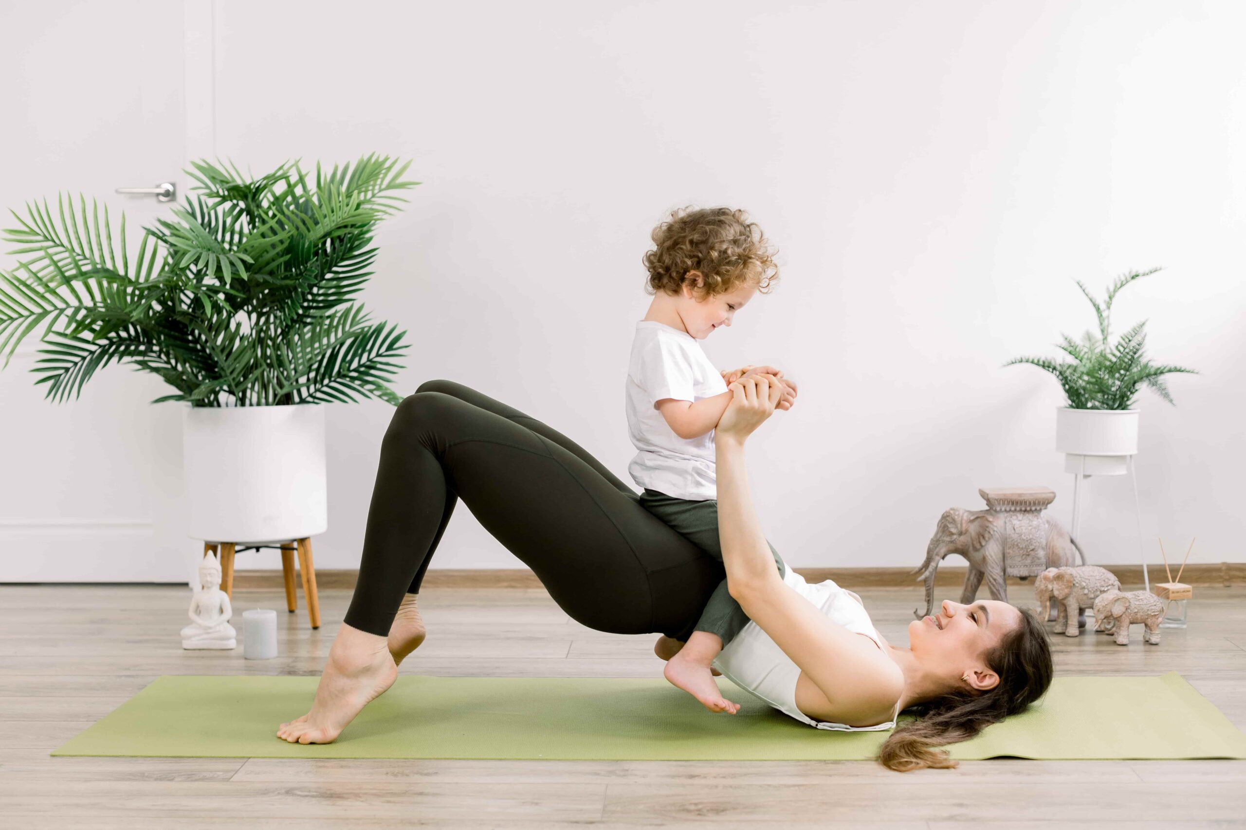 Postnatal fitness, a woman working out with her child.