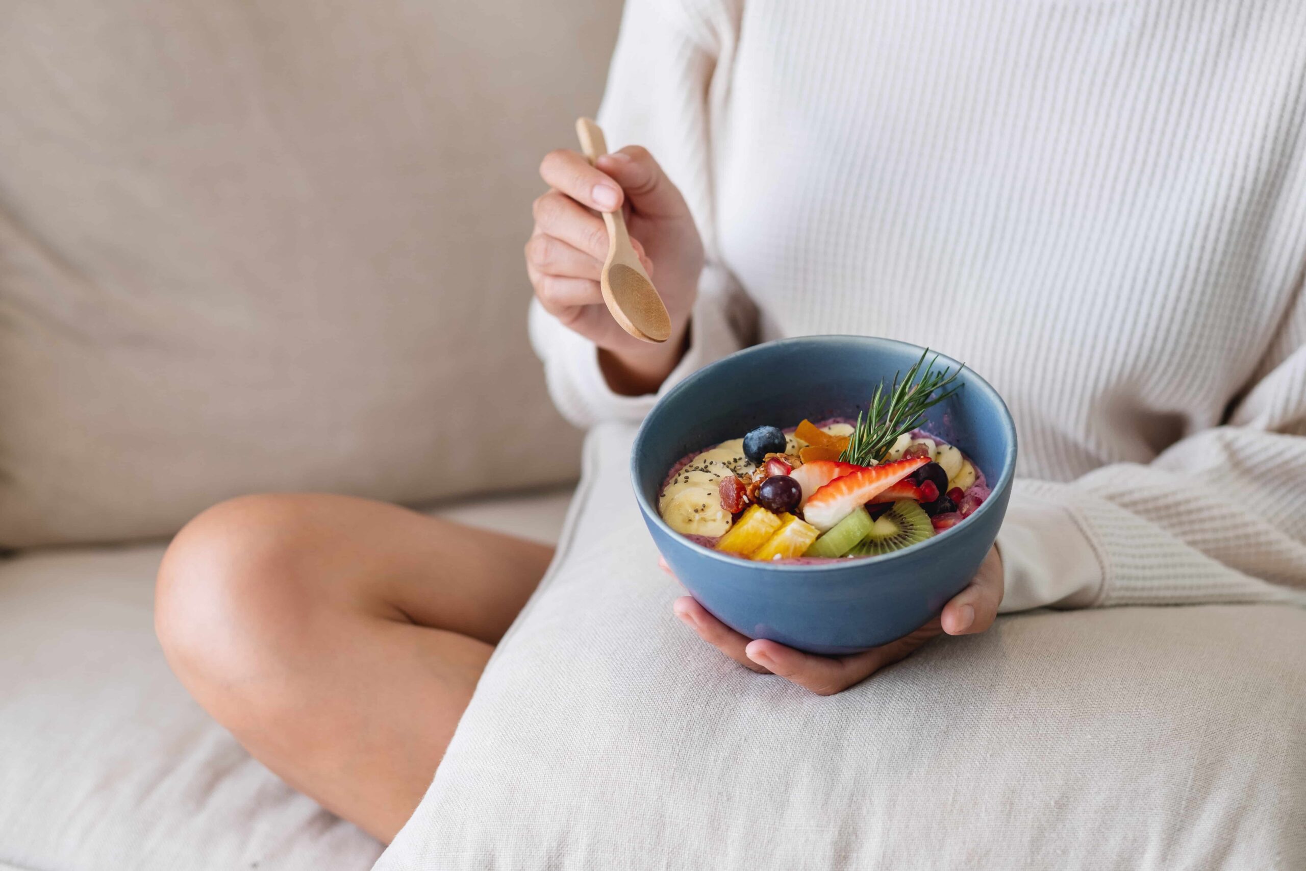 Meal prepping, a person eating from a smoothie bowl.